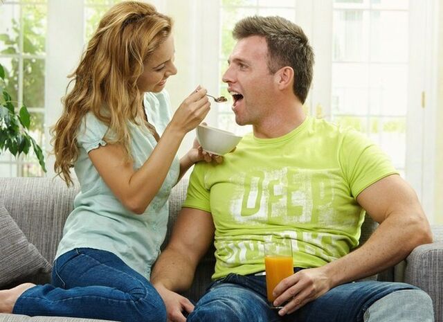 The woman feeds the man products to increase potency.